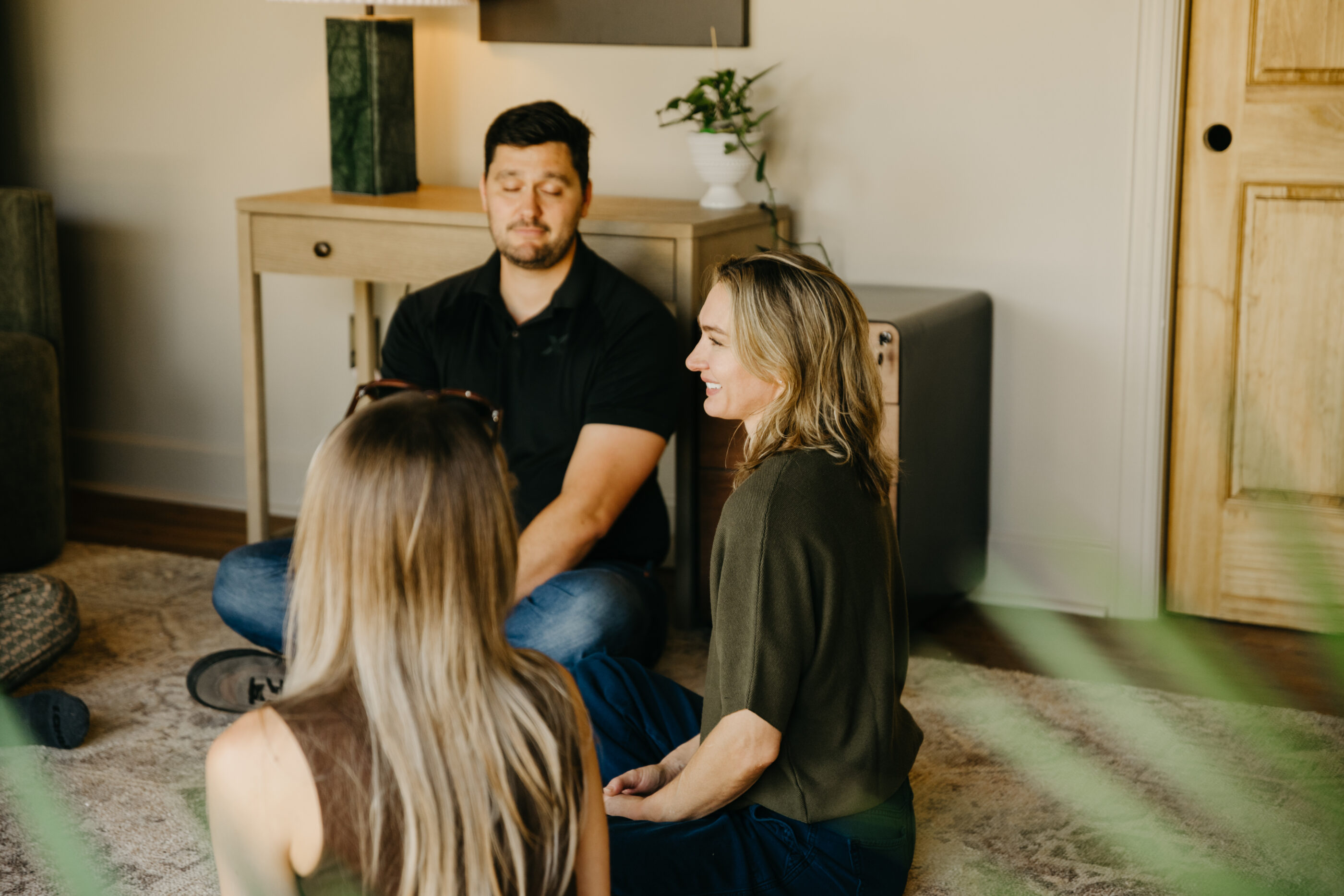 Group photo of a man and two women participating in a group therapy session